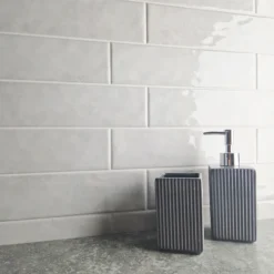 nebula rustic gloss white ceramic wall tile in 75x300 tiled on to a kitchen splash back in brick effect.