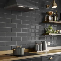 metro dark grey gloss ceramic wall tiles in 100x300mm installed on a kitchen splash back