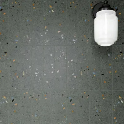 terrazzo dark grey 75x300mm tiles on a wall in soldier style.