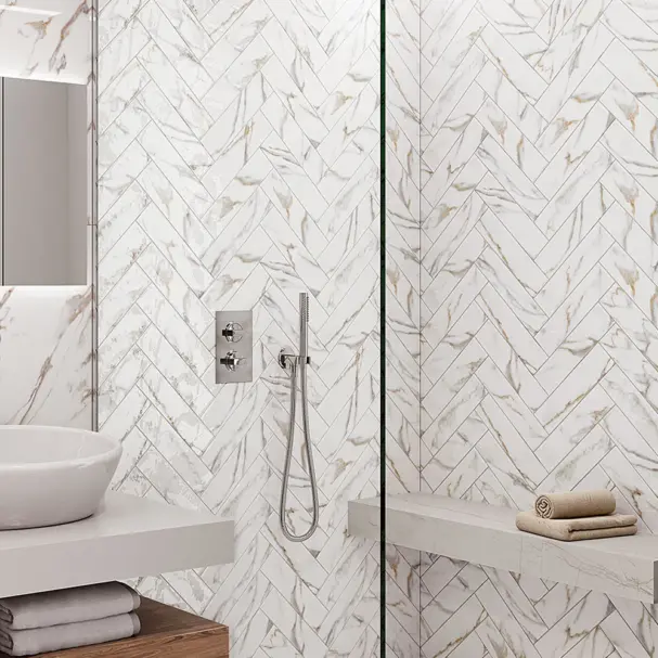 marble gold wall tile in 75x300mm in herringbone style in a shower.